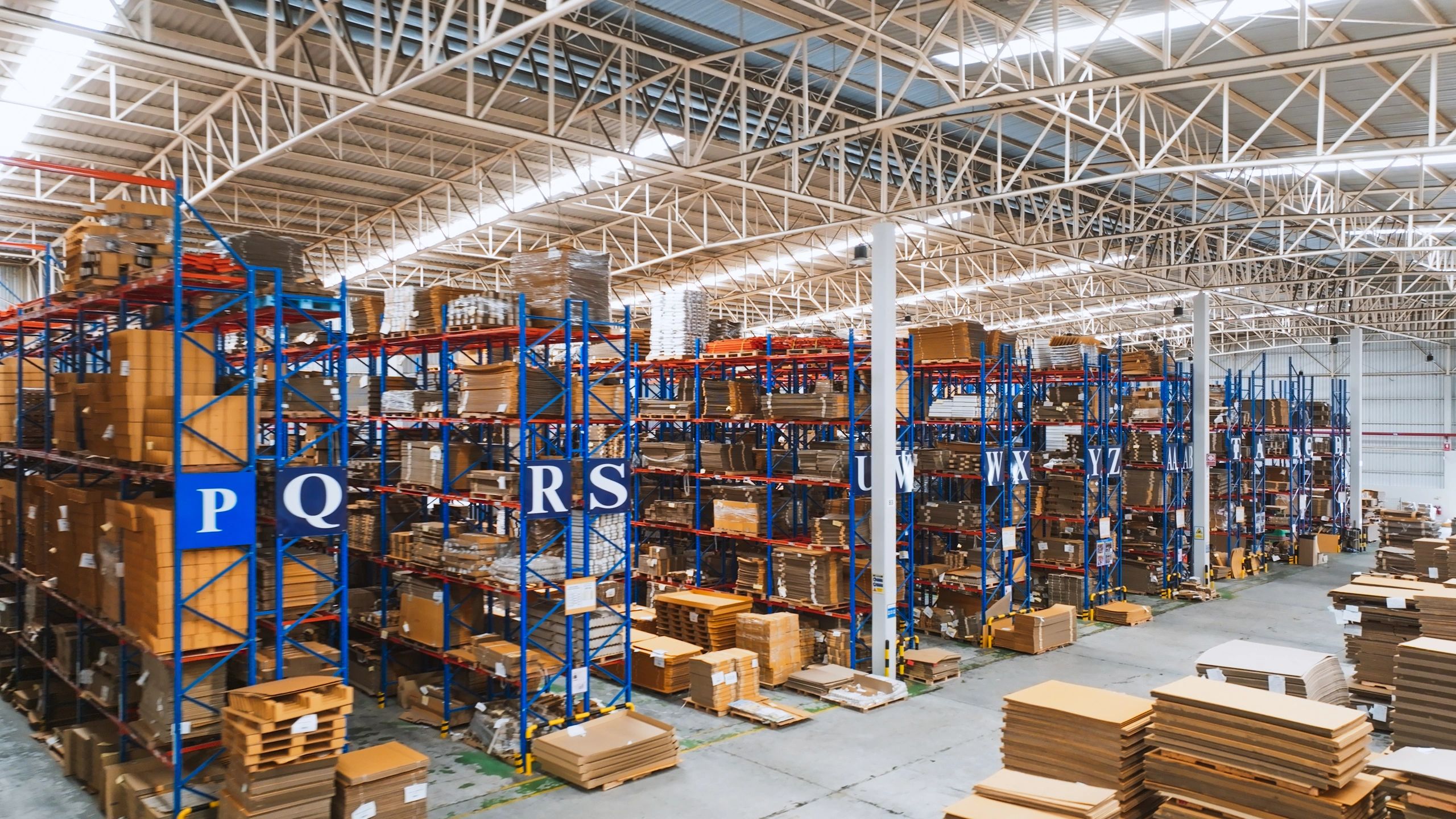 Warehouse shelving with packaged merchandise for sourcing and fulfillment